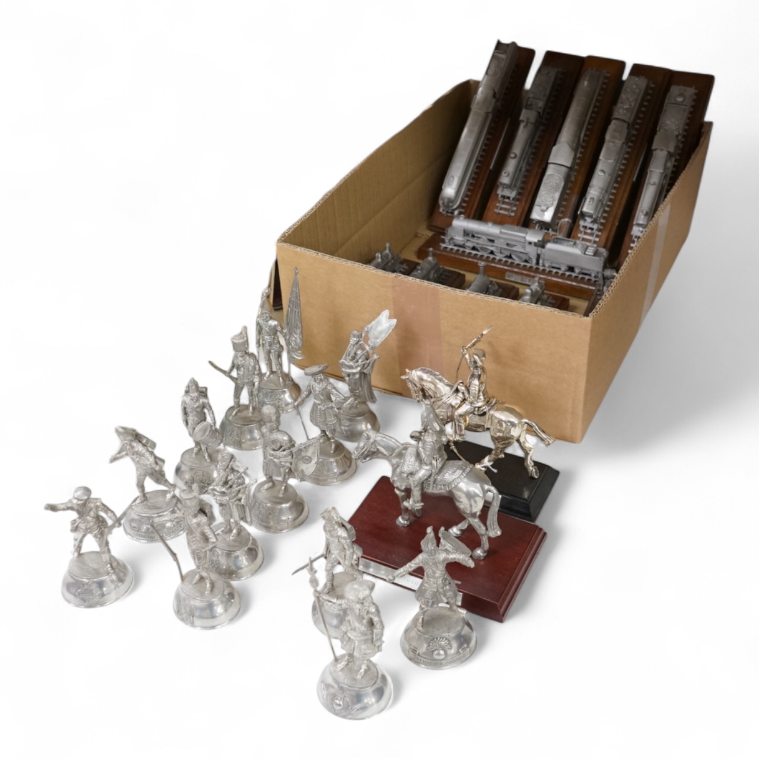 Thirteen small pewter models of soldiers, two similar mounted figures and twelve scale models of trains, largest 26cm in length